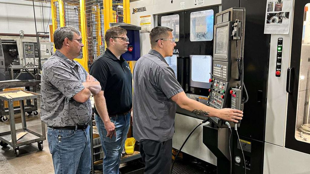 Eagle CNC staff programming a robotic cell fitted with an Okuma 2SP-2500H